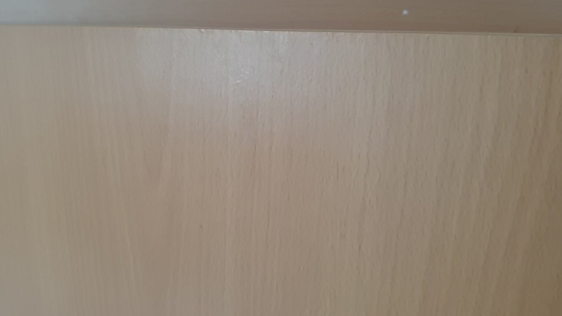 Close-up of light wood surface, showing natural grain and texture ideal for furniture or decor backgrounds.